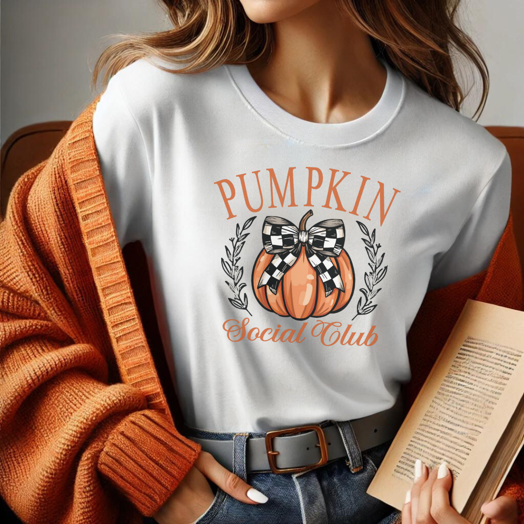 Welcome to the Pumpkin Social Club—where fall fashion meets festive fun! This delightful t-shirt features a stylish pumpkin adorned with a chic black and white checkered bow, surrounded by elegant text that reads "Pumpkin Social Club." Perfect for anyone who loves to celebrate the cozy vibes of autumn, this shirt is a must-have for pumpkin patch visits, hayrides, or just sipping on a warm pumpkin spice latte.