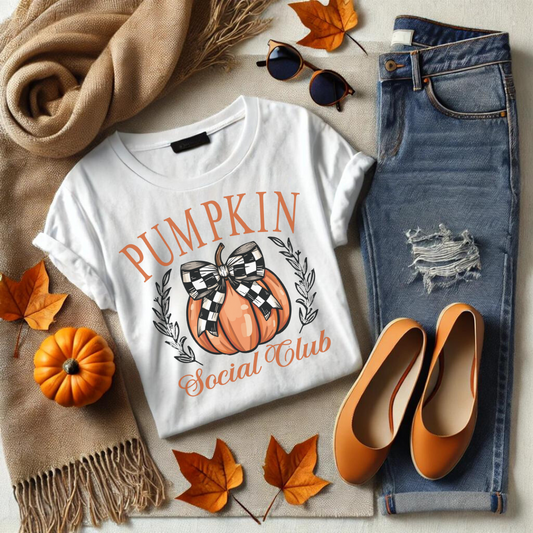 Welcome to the Pumpkin Social Club—where fall fashion meets festive fun! This delightful t-shirt features a stylish pumpkin adorned with a chic black and white checkered bow, surrounded by elegant text that reads "Pumpkin Social Club." Perfect for anyone who loves to celebrate the cozy vibes of autumn, this shirt is a must-have for pumpkin patch visits, hayrides, or just sipping on a warm pumpkin spice latte.