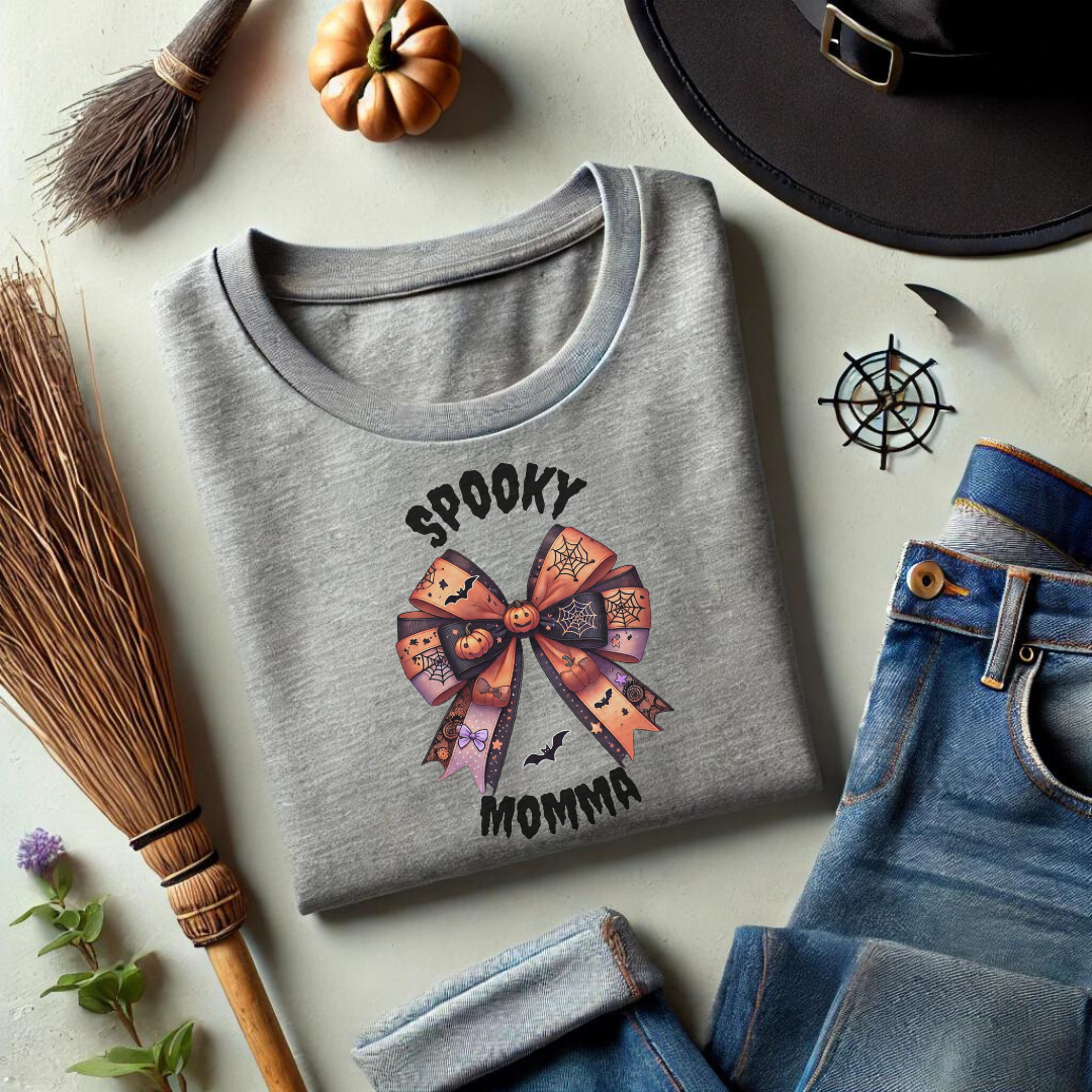 Embrace the spooky season in style with our Spooky Momma t-shirt! This unique design features a charming Halloween coquette bow adorned with pumpkins, bats, and spider webs, capturing the perfect blend of cute and creepy. The "Spooky Momma" text adds a fun, festive touch, making this shirt a must-have for any Halloween-loving mom.